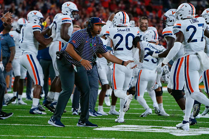 Virginia Cavaliers head coach Tony Elliott greets his players coming off the field during the second half against the Syracuse Orange at JMA Wireless Dome.
